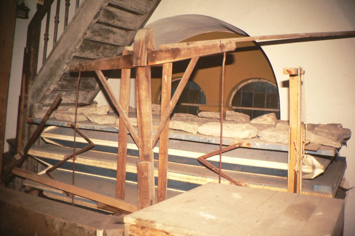 A dilapidated historic wedge bellows photographed before restoration work
