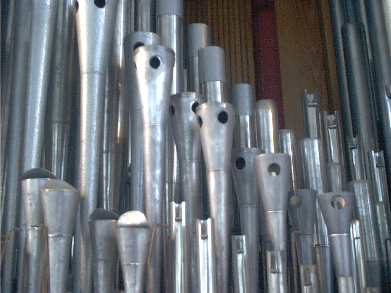 Close detail of gleaming metal organ pipe mouths in a new completed rank