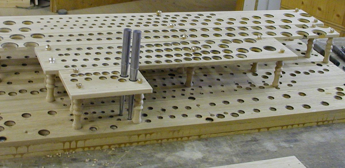 A pre-assembled pipe toe-board on the bench in an organ-building workshop