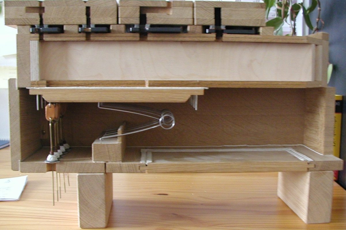 Cutaway model of a pipe organ windchest showing the internal pallet and channel mechanism